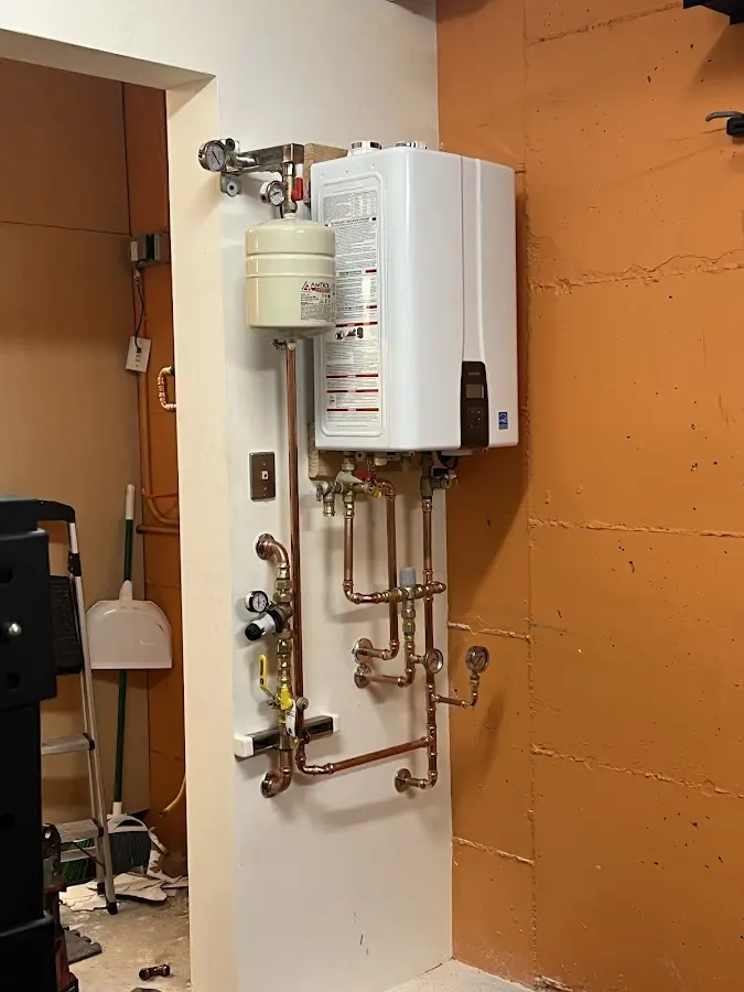 Plumbing technician inspecting water heater connections in Breaux Bridge